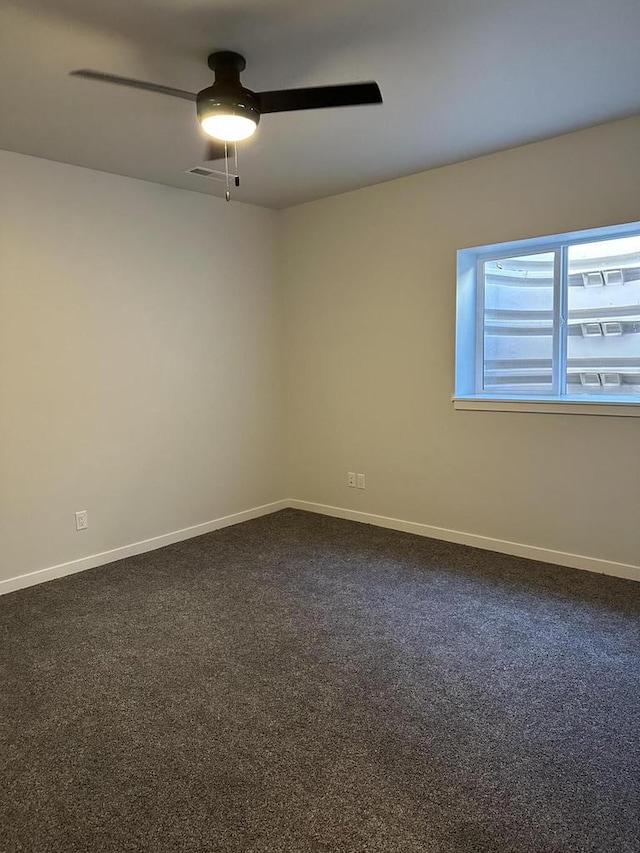 carpeted empty room featuring ceiling fan