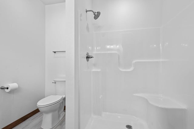 bathroom with toilet and a shower