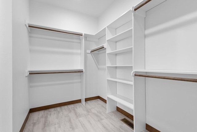 walk in closet featuring light hardwood / wood-style floors