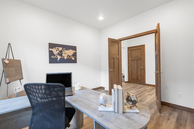 home office with hardwood / wood-style floors