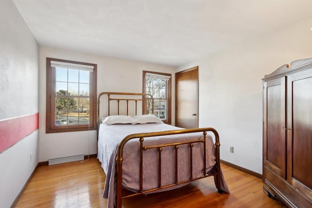 bedroom with light wood-type flooring and multiple windows