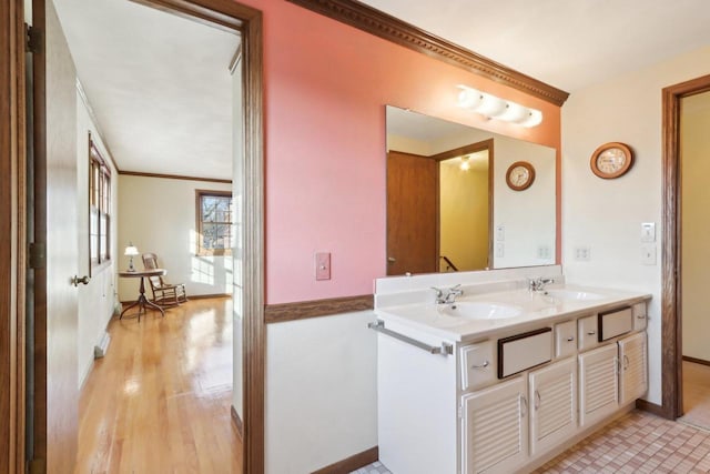 bathroom with hardwood / wood-style flooring, vanity, and crown molding