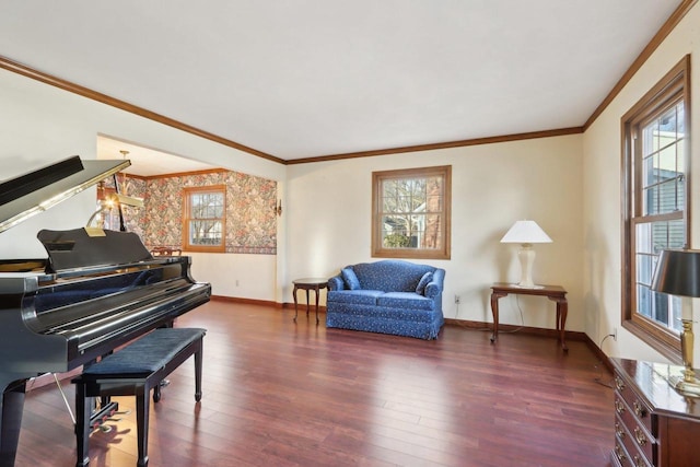 sitting room featuring dark wood-type flooring, a wealth of natural light, and crown molding