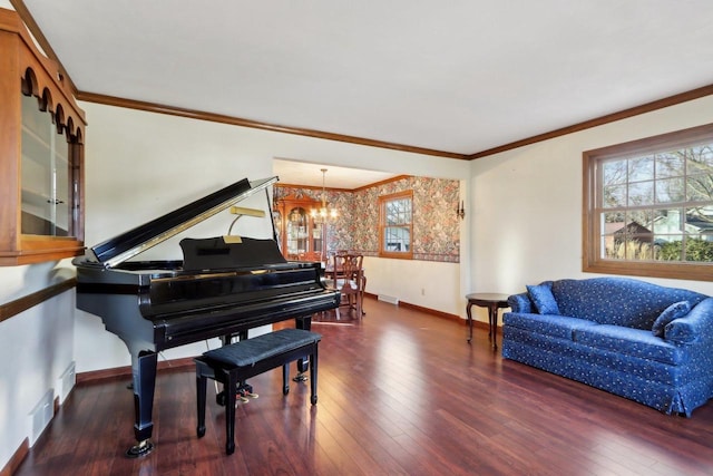 sitting room with dark hardwood / wood-style floors, crown molding, and a notable chandelier