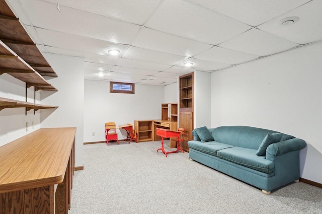 recreation room with carpet and a paneled ceiling