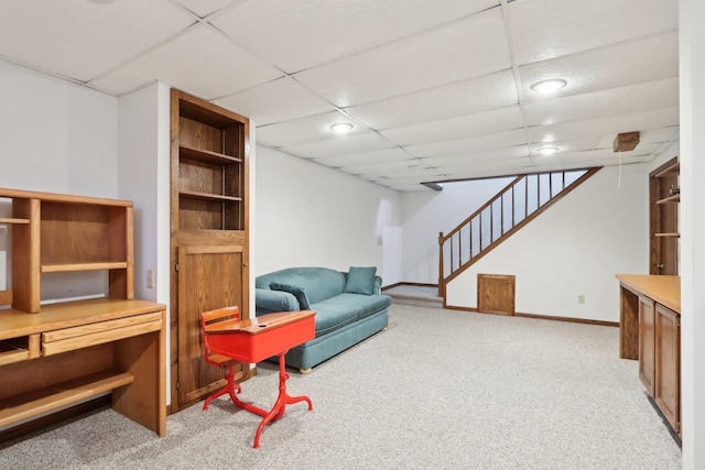 living room with light colored carpet and a drop ceiling