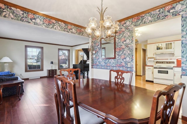 dining room with light hardwood / wood-style floors, ornamental molding, and a chandelier