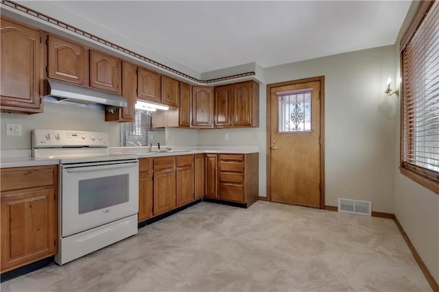 kitchen with white electric range oven and sink