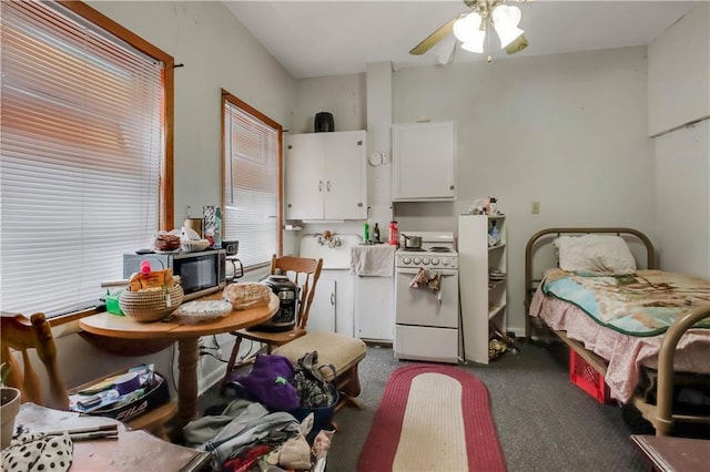 kitchen featuring ceiling fan, white cabinetry, white electric range oven, and dark colored carpet