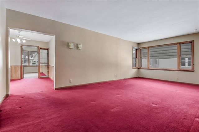 spare room featuring ceiling fan and light colored carpet