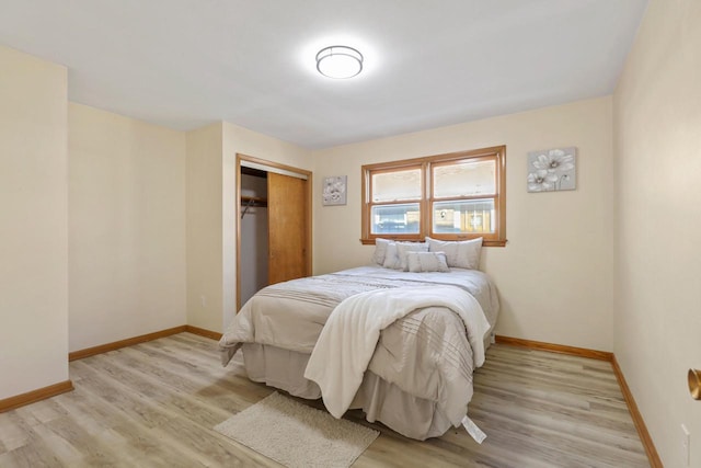 bedroom with a closet and light hardwood / wood-style flooring