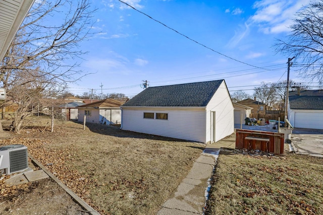 view of property exterior featuring central air condition unit and a lawn