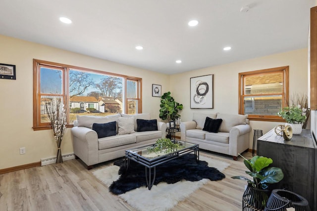 living room featuring baseboard heating and light hardwood / wood-style flooring