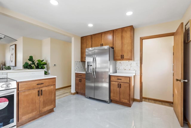 kitchen with stainless steel appliances and decorative backsplash