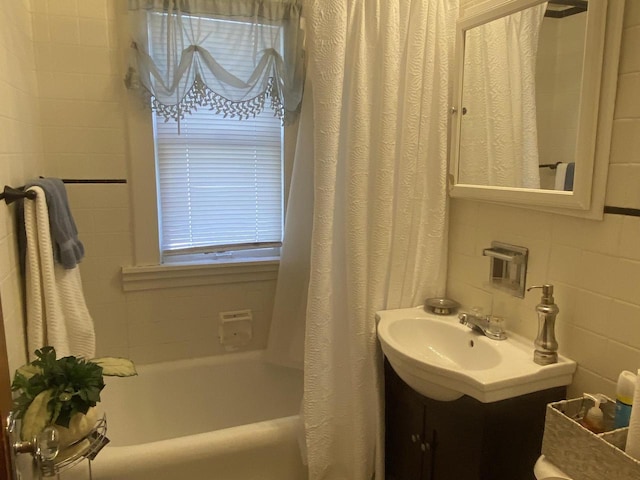 bathroom featuring vanity and shower / bath combination with curtain