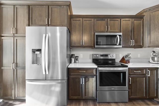 kitchen featuring dark hardwood / wood-style flooring, stainless steel appliances, and dark brown cabinetry