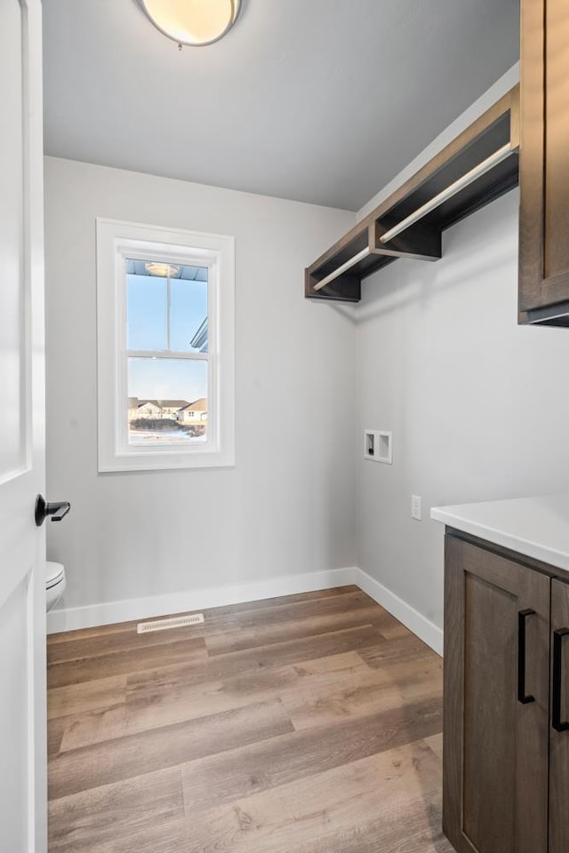 laundry area with light wood-type flooring and washer hookup