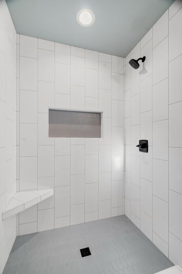 bathroom with a tile shower
