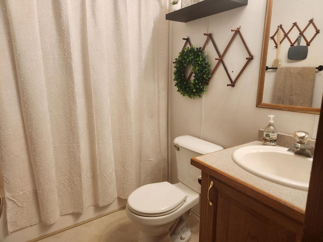 bathroom with toilet, vanity, and walk in shower