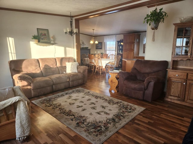 living room with dark hardwood / wood-style floors, crown molding, and an inviting chandelier