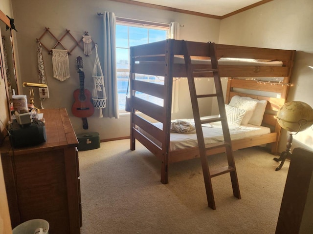 carpeted bedroom with ornamental molding