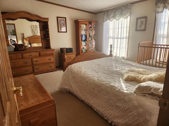 bedroom with ornamental molding and carpet