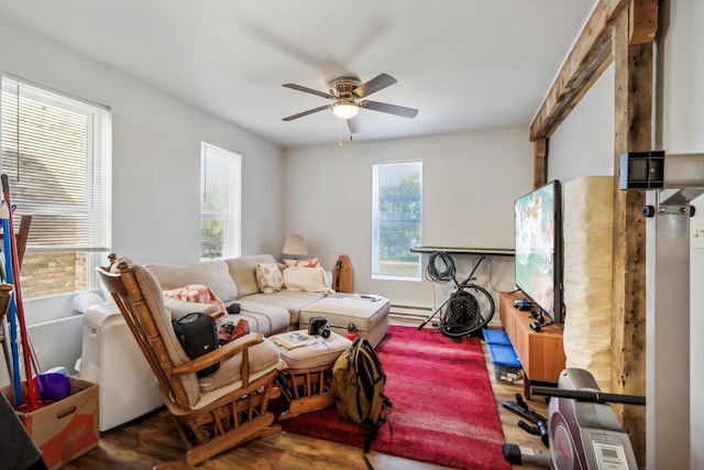 living room featuring ceiling fan and baseboard heating