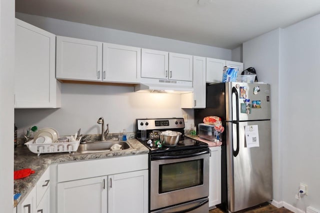 kitchen featuring white cabinets, appliances with stainless steel finishes, sink, and stone counters