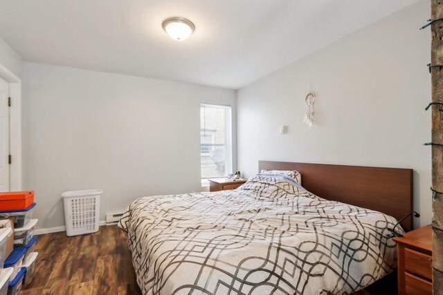 bedroom with dark hardwood / wood-style flooring