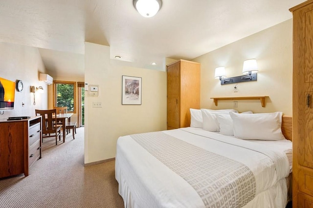 bedroom featuring light carpet and an AC wall unit