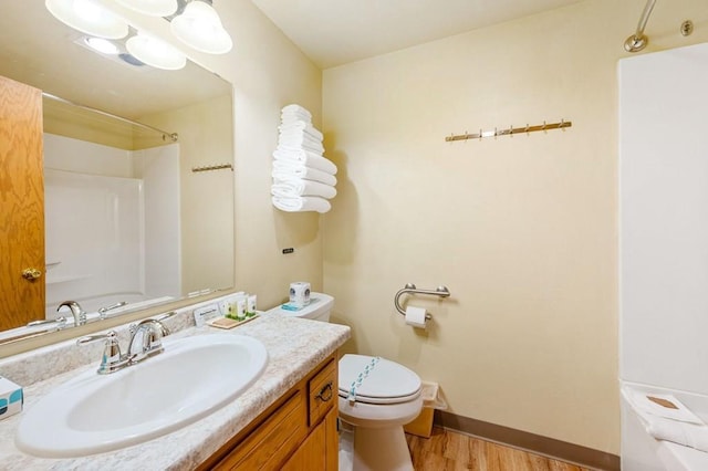 bathroom featuring toilet, vanity, and wood-type flooring