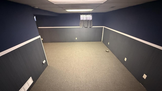 basement with carpet and a drop ceiling