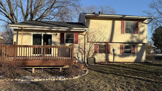 back of property with central air condition unit, a wooden deck, and a yard