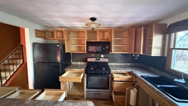 kitchen with sink, black appliances, and wood-type flooring