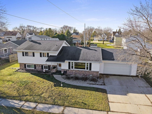 view of front of home with a garage and a front yard