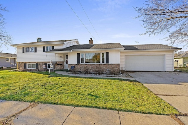 split level home featuring a garage and a front lawn