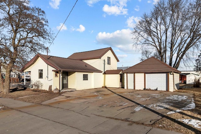 view of front of house with a garage and an outdoor structure