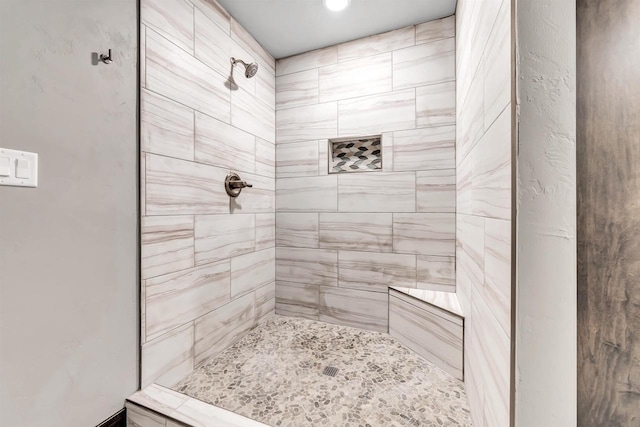 bathroom featuring a tile shower