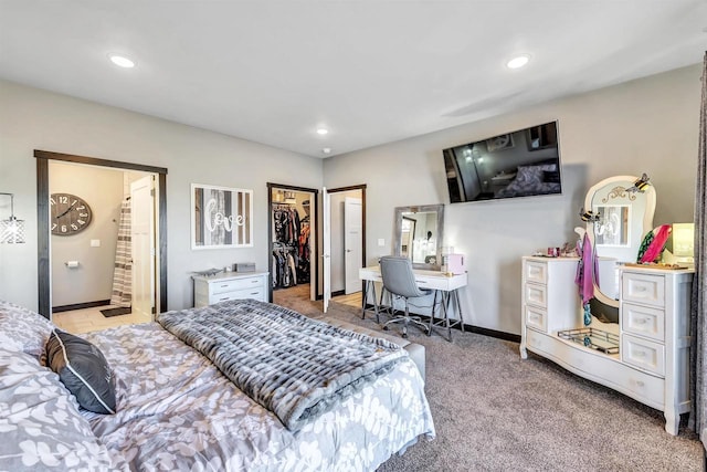 carpeted bedroom featuring a closet and a walk in closet