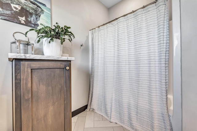 bathroom featuring vanity, shower / tub combo, and tile patterned flooring