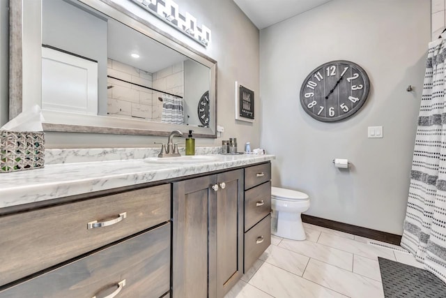 bathroom featuring toilet, vanity, and a shower with curtain