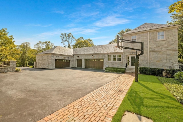 view of front of property featuring a garage and a front lawn