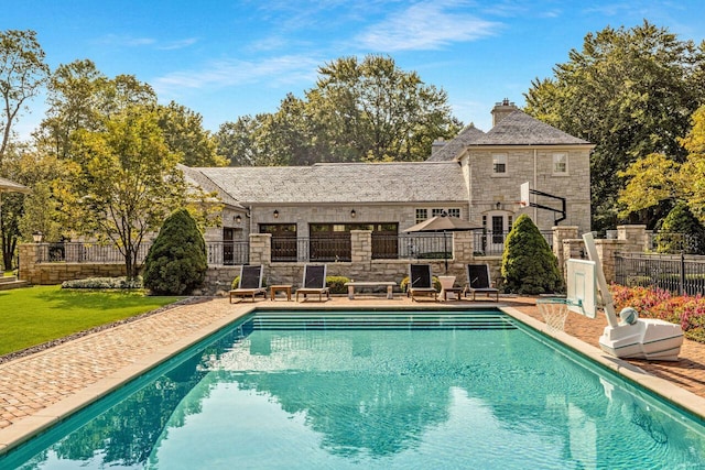 view of swimming pool with a lawn and a patio area