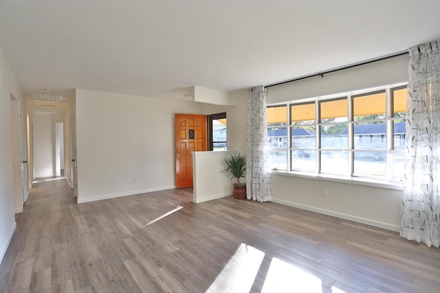 spare room featuring light hardwood / wood-style flooring