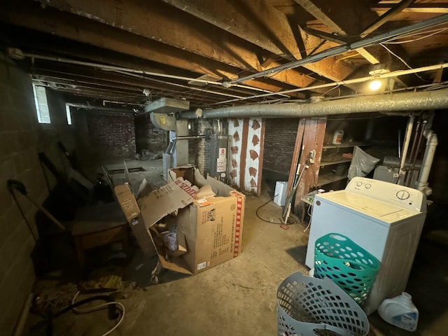 basement featuring gas water heater and washer / clothes dryer