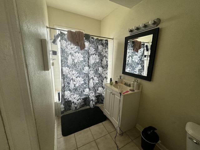 full bathroom featuring shower / bath combo with shower curtain, toilet, vanity, and tile patterned flooring