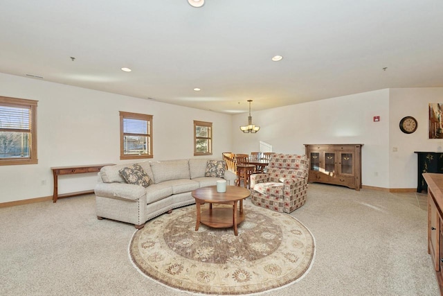 living room featuring a notable chandelier and light colored carpet