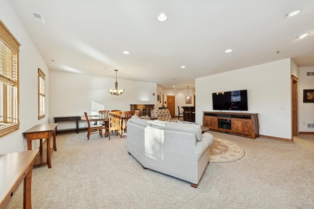 living room featuring a chandelier and light colored carpet