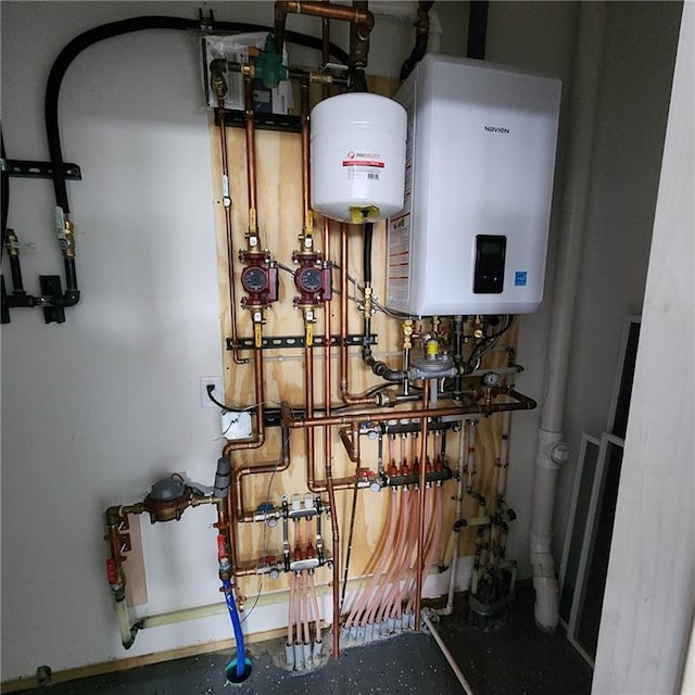 utility room featuring tankless water heater