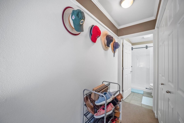 corridor featuring crown molding and light tile patterned floors